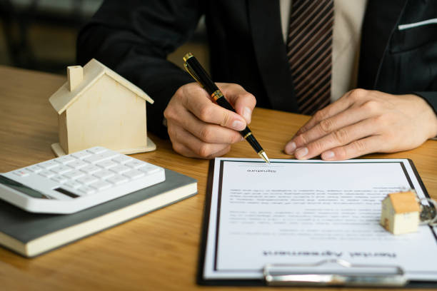 istock Sales representatives work at the desk with home purchase contracts or on office loans and interest rates. 1333388046