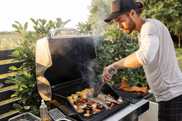 istock Man cooking on a grill outdoors 1333389248
