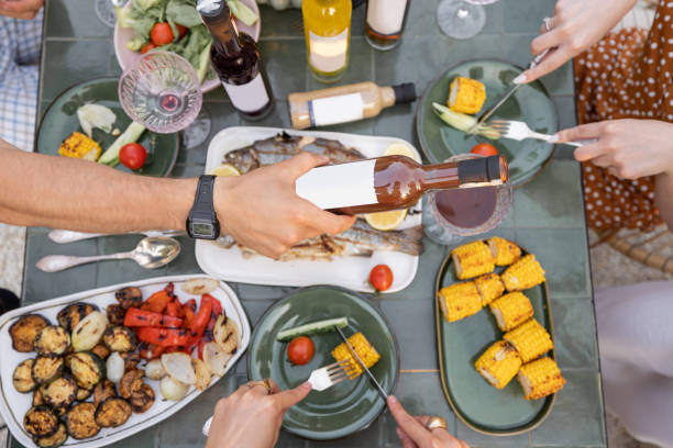 istock People eating and drinking at beautifully served table 1333389313