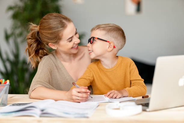 istock Happy mother supporting son during online studies 1333390640