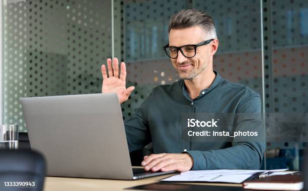 Executive Businessman Using Laptop Having Video Conference Call Virtual Meeting Stock Photo - Download Image Now