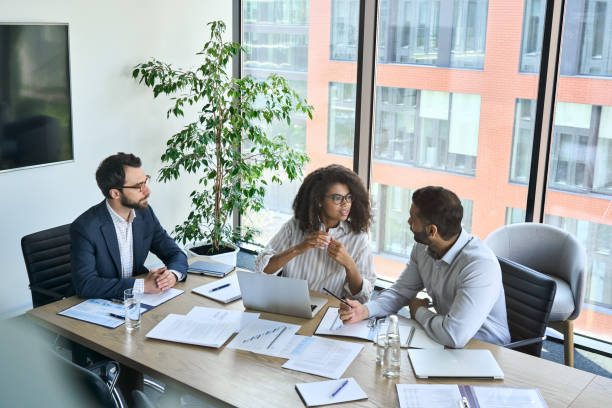 istock Diverse executive business team people discuss project at meeting in board room. 1333390948