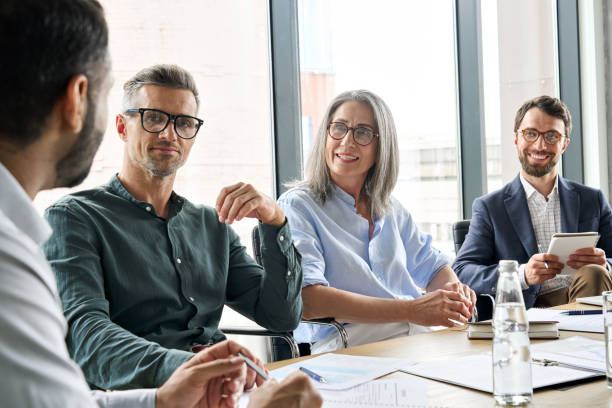 istock Executive team people listening ceo discussing project at board meeting. 1333390954
