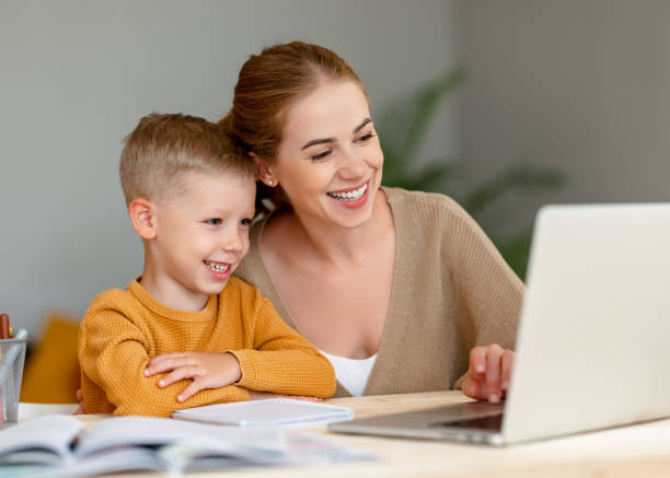 istock Happy mother supporting son during online studies 1333390967
