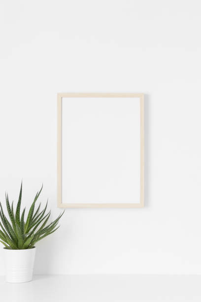 istock Wooden frame mockup on the wall with a succulent plant. 1333391917