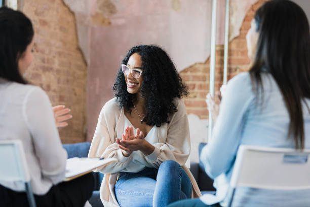 istock Diverse women smile and clap for unseen group member 1333397837