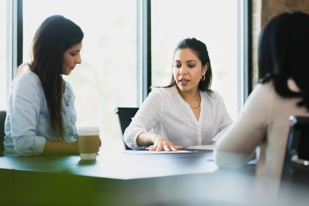 istock Two women discuss documents with female lawyer 1333397839