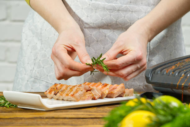 istock Chef decorating sliced fried tuna fish with vegetables 1333397923