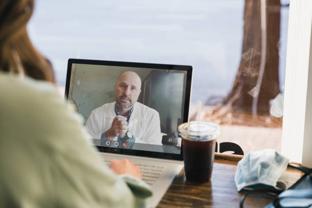 istock Unrecognizable woman has video conversation with doctor during COVID-19 1333398178