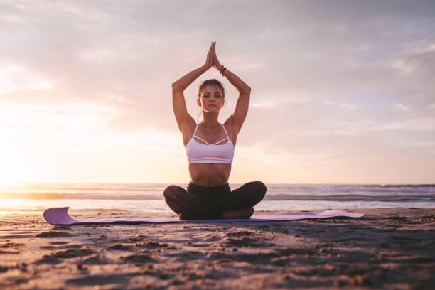 istock Woman in meditation on the beach 1333398943
