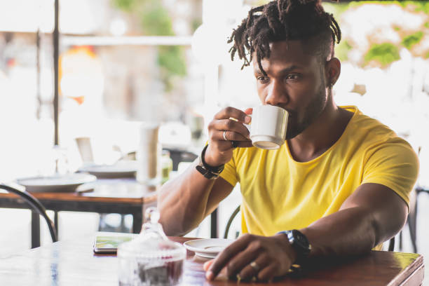 istock Man drinking a cup of coffee at a coffee shop. 1333399012