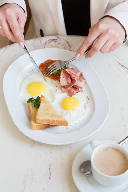 istock Woman eating english breakfast with milk tea 1333399151