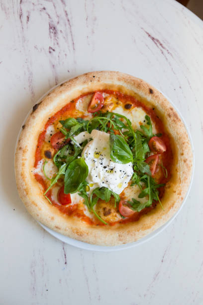 Buratta cheese on a neapolitan pizza on a table