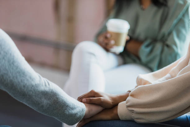 istock Unrecognizable woman comforts friend during group therapy 1333403149