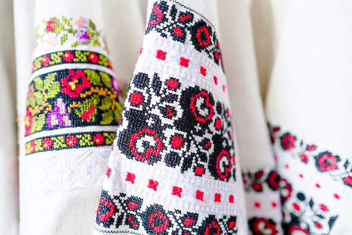 Close up color image depicting colorful, traditional Romanian (and eastern European) clothing for sale on a market stall. There are many different colored patterns and designs to choose from. Room for copy space.