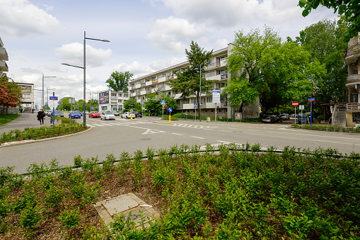 Warsaw, Poland - May 24, 2021: General view along the main street on the estate called Saska Kepa . There are a lot of trees here, and there are also residential buildings.