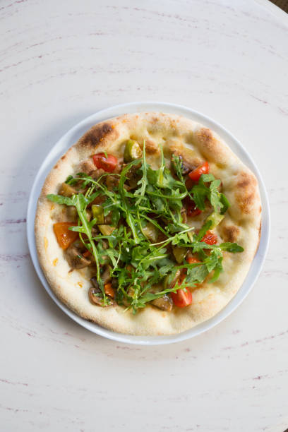 istock Whole round baked neapolitan pizza on a table 1333404119