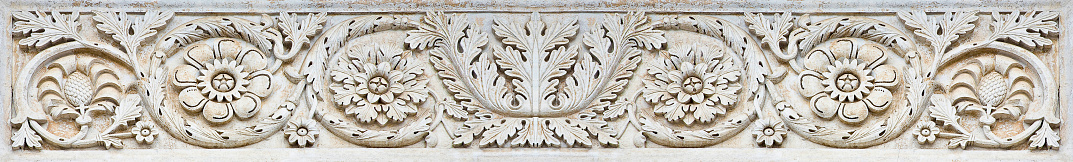 Aged roman frame of carved stone with geometric and foliage shape