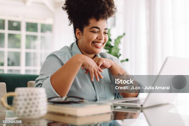 Positive Woman Video Calling Using Laptop At Home Stock Photo - Download Image Now - Women, One Woman Only, People