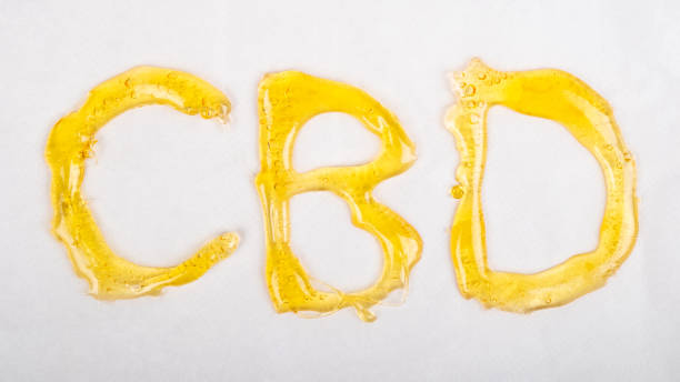 golden cbd lettering, oil extract with cannabis wax stock photo