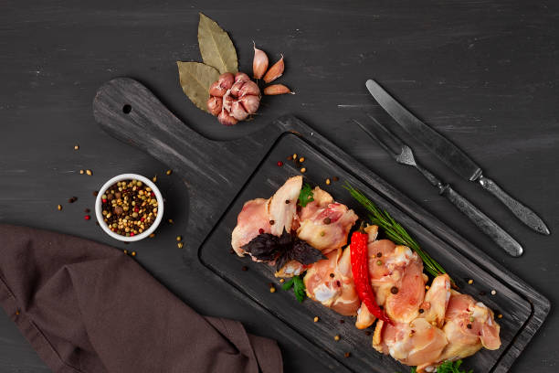 istock Raw chicken joints, with spices, on a  wooden table, top view, rustic style, no people, 1333405619