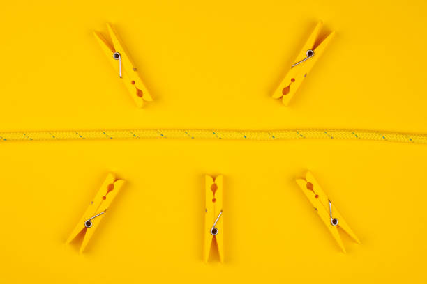 Yellow clothespins and rope. Catch your luck. Yellow background. Lucky break concept.