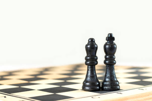 istock Black king and queen chess pieces on chessboard 1333409421