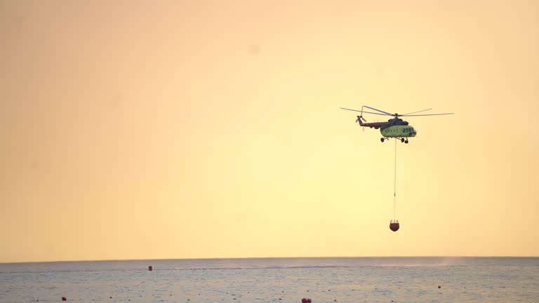 Fire fighting helicopter with  basket loading water