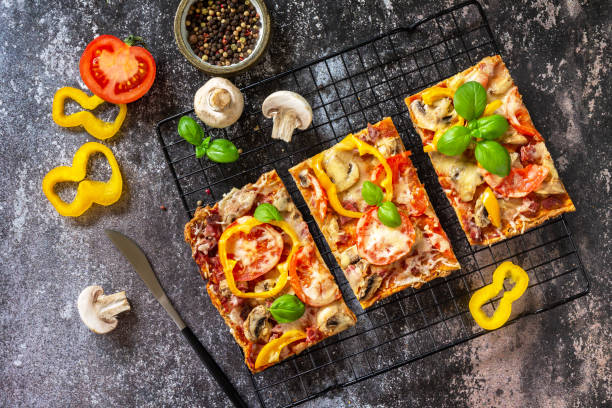 istock Homemade baking Detroit-Style pizza. Large rectangular Pepperoni pizza with mushrooms, salami and cheese on a stone tabletop. Top view flat lay background. 1333418017