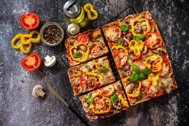istock Homemade baking Detroit-Style pizza. Large rectangular Pepperoni pizza with mushrooms, salami and cheese on a stone tabletop. Top view flat lay background. 1333418021