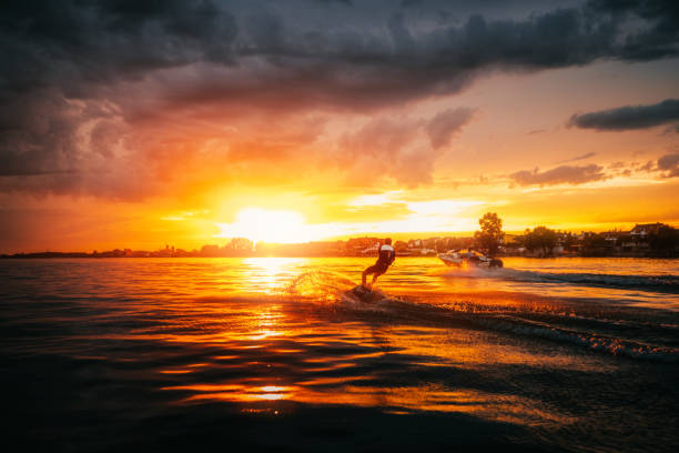 istock A silhouette of a wake boarder riding a wave 1333419274