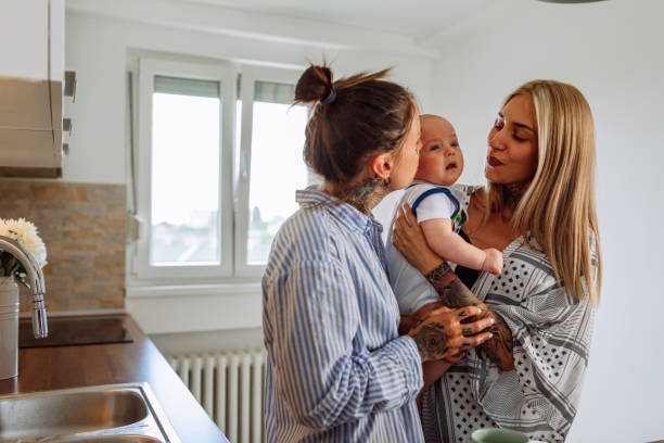 istock Happy mothers playing with baby at home 1333419905