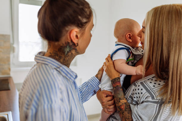 istock Loving young lesbian couple with baby in kitchen 1333419908