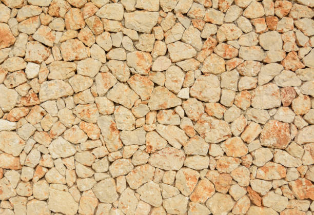 istock natural stone wall, sand color texture 1333421510