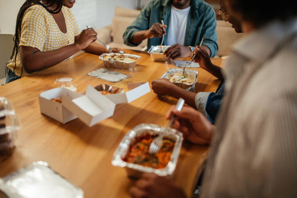 istock Black friends ordering and eating delivery food 1333421704