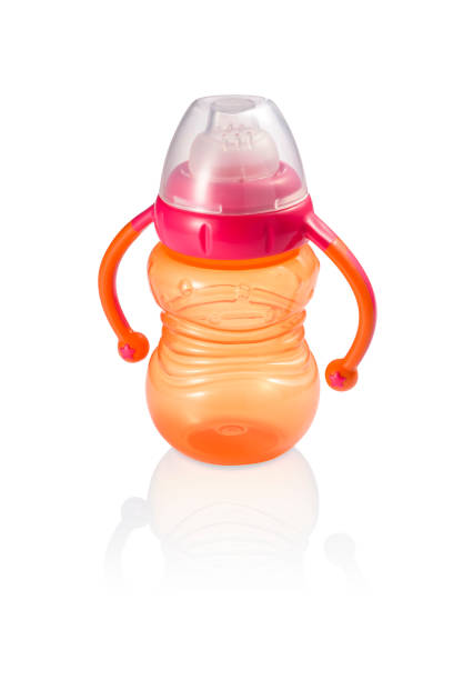 istock Fun orange baby bottle with handles and pink ring isolated 1333423435