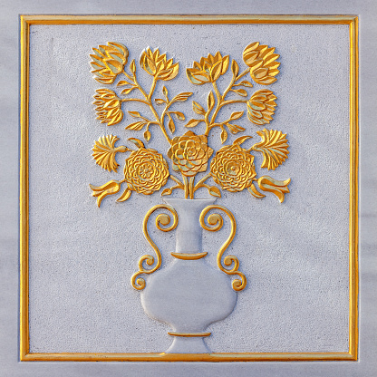 Flowers and vase carved from white marble relief with golden foil
