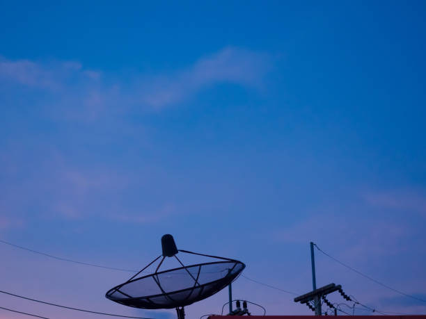istock silhouette satellite dish on roof with twilight blue sky 1333424494