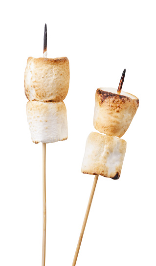 Fried marshmallows on skewers close-up on a white plate, cut marshmallows. Isolated