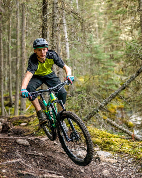 istock View of mountain biker getting air off jump in forest 1333425935