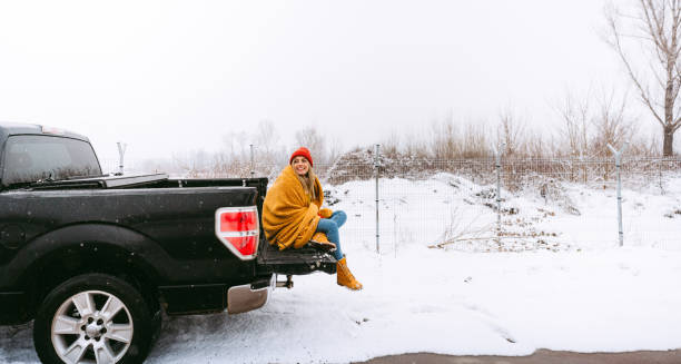 istock Young woman on a winter road trip 1333428862