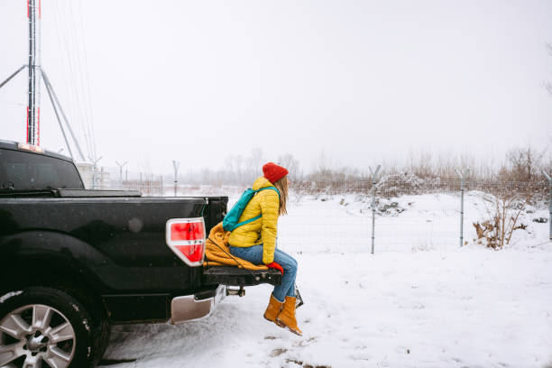 istock Young woman on a winter road trip 1333428881
