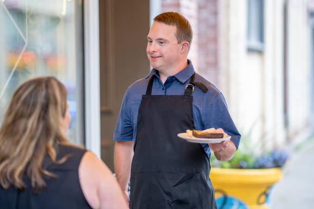 istock Waiter with Down syndrome working at a restaurant 1333429775