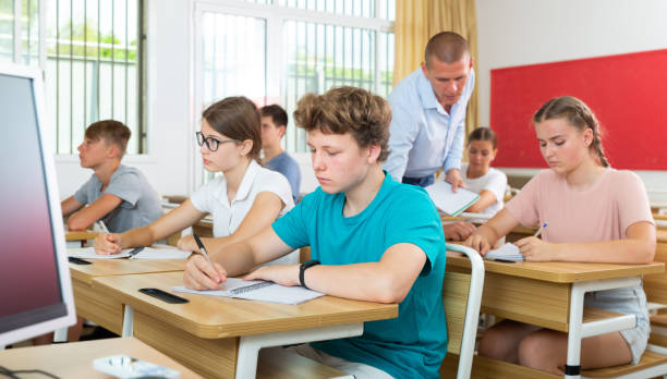 istock Pupils sitting in class and listening 1333429990