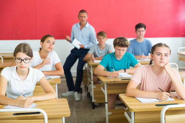 istock Teenager students sitting at desks 1333430005