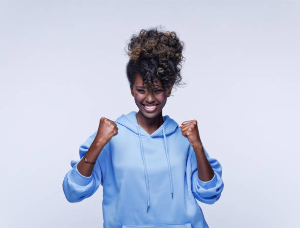 istock Excited young woman in blue hoodie 1333432425
