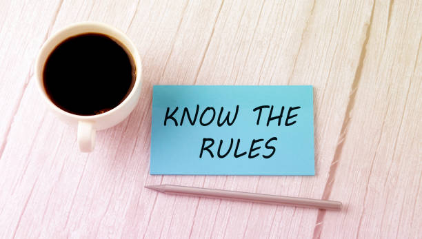 Know the Rules text on blue sticker with cofee and pen stock photo