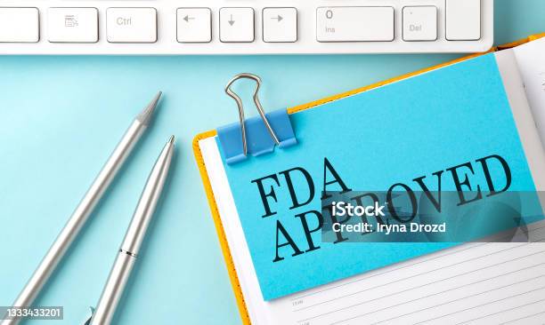 Fda Approved Text On Sticker On The Blue Background With Pen And Keyboard Stock Photo - Download Image Now