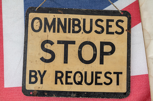 Vintage Omnibus Stop By Request Bus Stop Sign on a Union Jack Flag