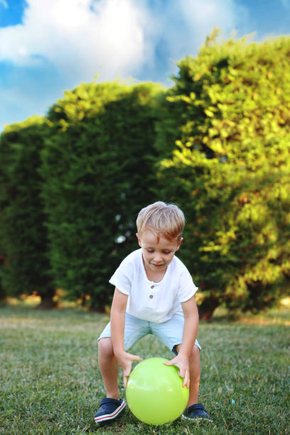 little cute boy playing with balloon in the park